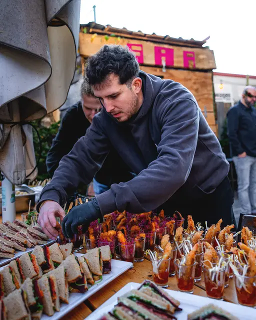 Koch richtet Fingerfood am Buffet an – Catering von Bordsteinschwalbe bei einer Weihnachtsfeier
